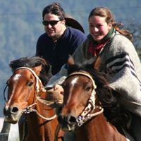 Edward and Lena racing their horses on a ride in Pucon, southern Chile.